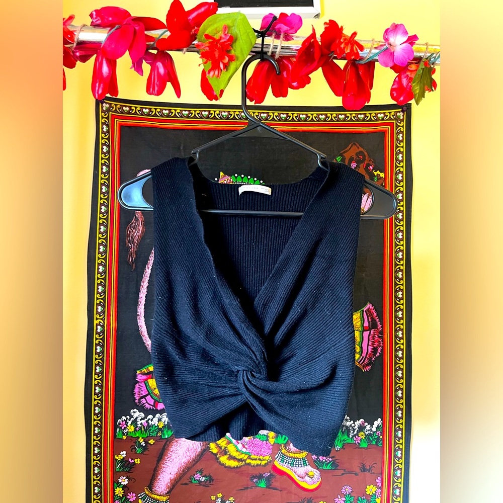 Cropped black top with a low neck line